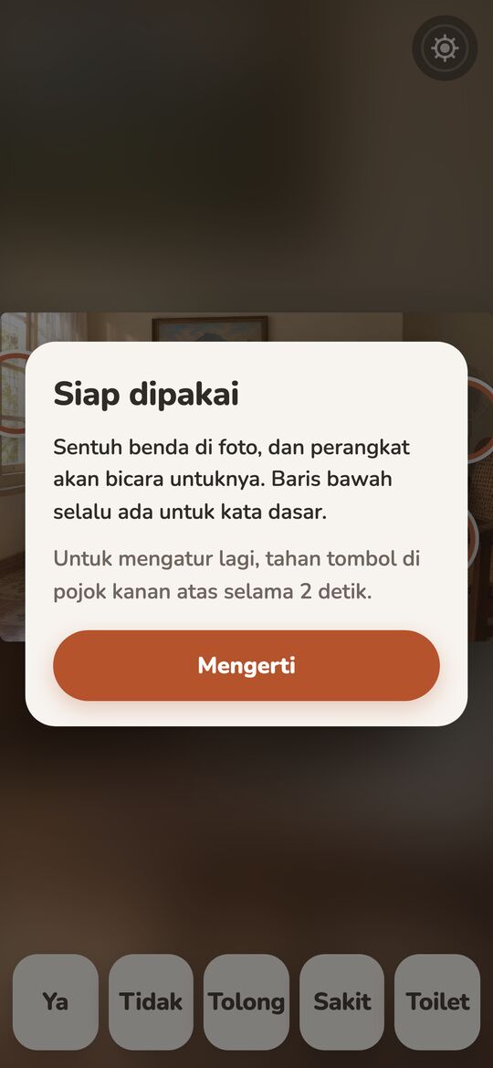 A one-time card for the caregiver, Siap dipakai (ready to use), explaining the 2-second hold.